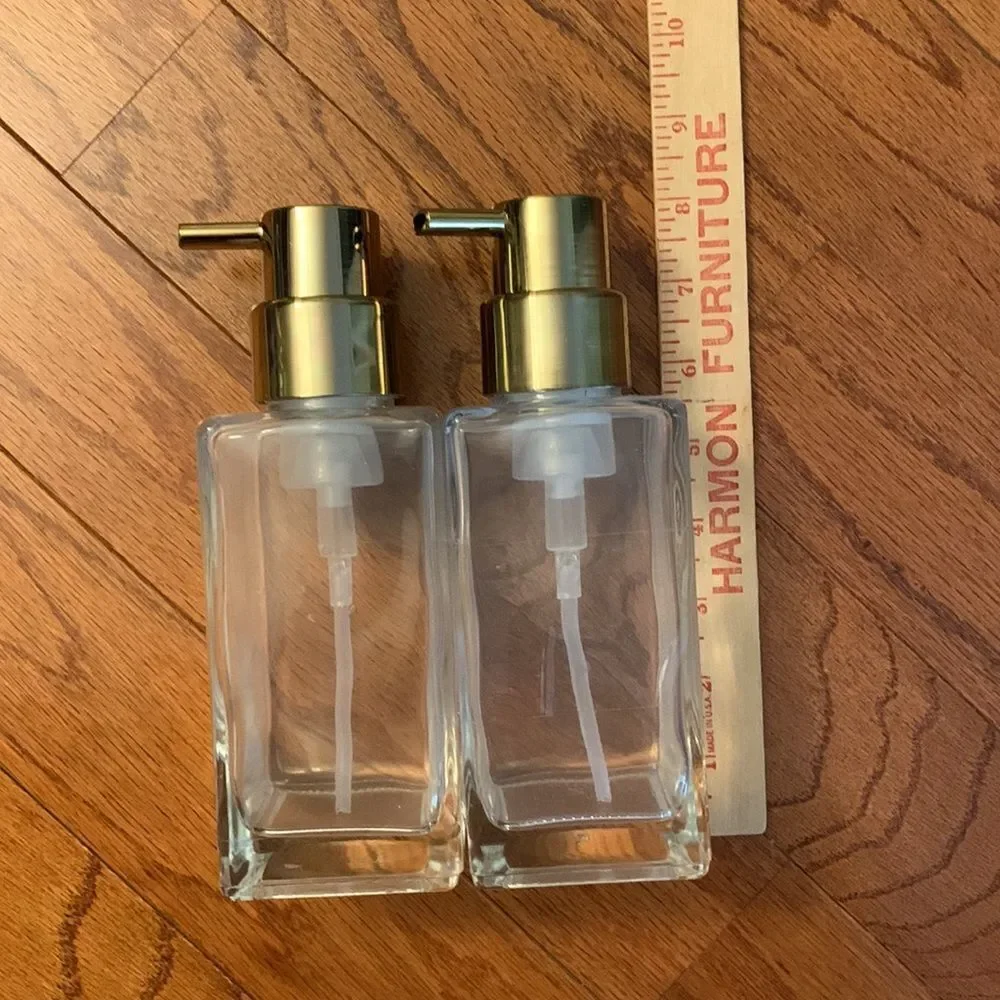 Set of TWO pump bottle refillable dispensers with goldtone tops